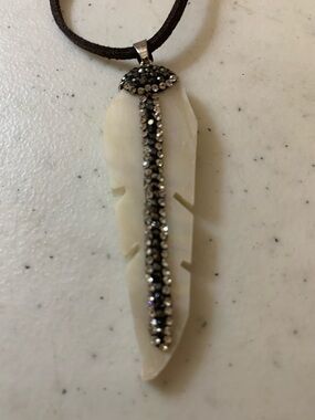 White bone or shell Feather Pendant with Black Crystal Accent.